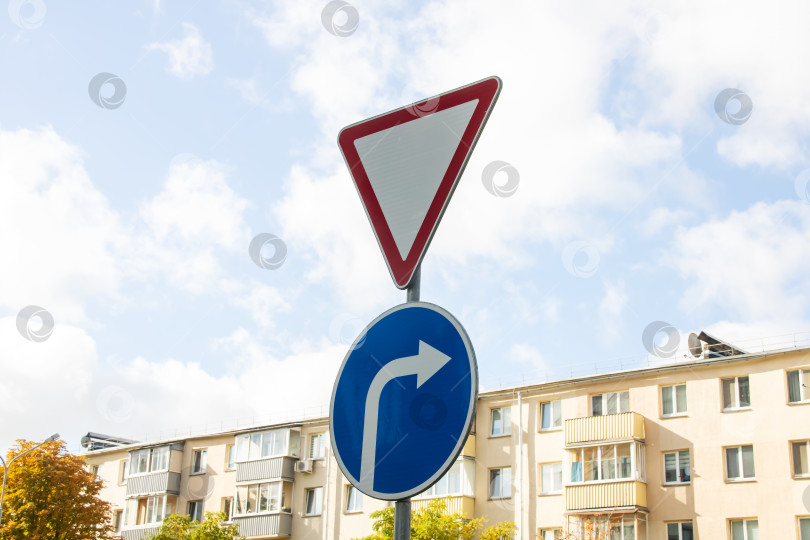 Скачать Дорожный знак "Уступи дорогу" на фоне голубого неба фотосток Ozero