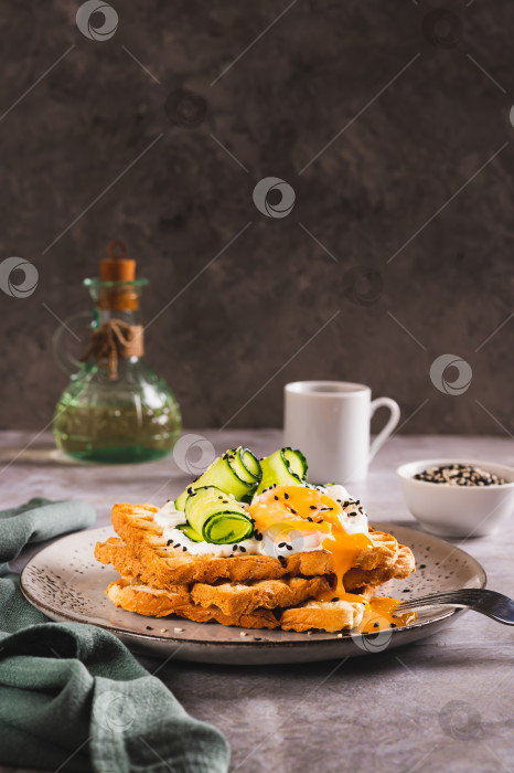 Скачать Тосты со сливочным сыром, огурцом, яйцом-пашот и кунжутом на тарелке в вертикальном положении фотосток Ozero