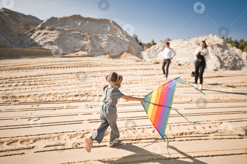 Скачать Ребенок играет с воздушным змеем на песке 3343. фотосток Ozero