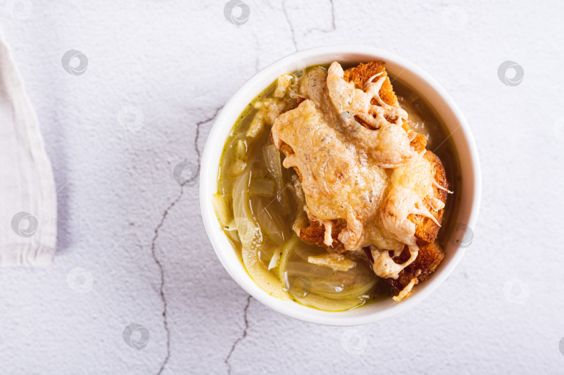 Скачать Крупный план домашнего лукового супа с гренками и сыром в миске на столе вид сверху фотосток Ozero