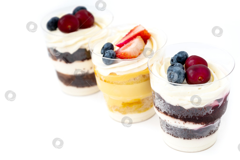 Скачать Ассортимент сладких пирожных со свежими ягодами на белом фоне фотосток Ozero