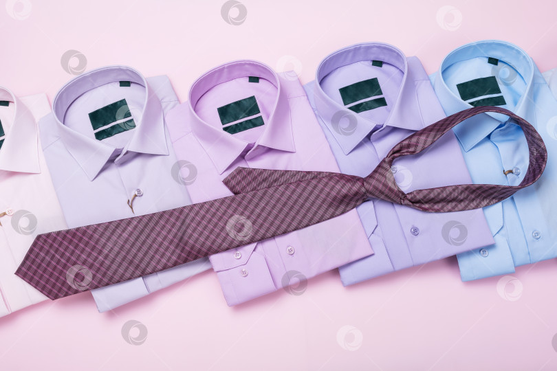 Скачать Разноцветные мужские рубашки и галстук на розовом фоне, концепция на тему подбора галстука, вид сверху фотосток Ozero