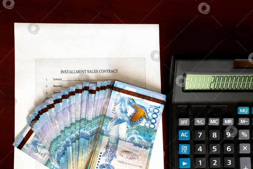 Скачать Тенге. Бумажные казахские деньги и калькулятор на столе крупным планом. фотосток Ozero