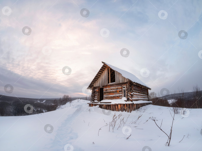 Скачать заброшенный дом на заснеженном склоне в зимних сумерках фотосток Ozero