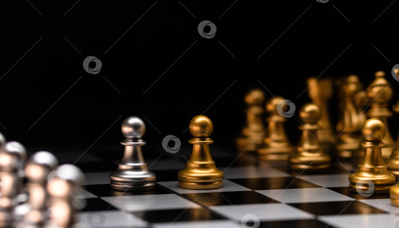 Скачать Сосредоточенная пешка. Серебряные шахматные фигуры и золотые соперники. фотосток Ozero