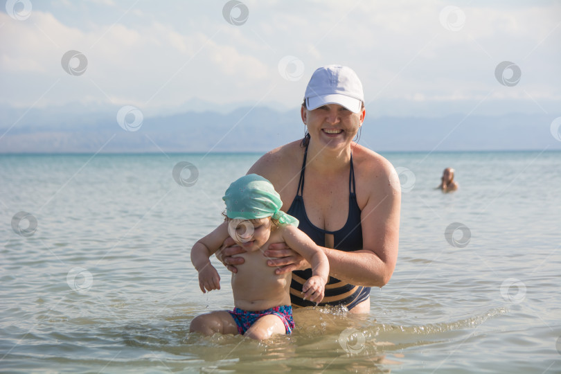 Скачать мама купает ребенка в горном озере фотосток Ozero