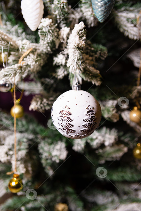 Скачать Декоративная рождественская безделушка на заснеженной елке фотосток Ozero