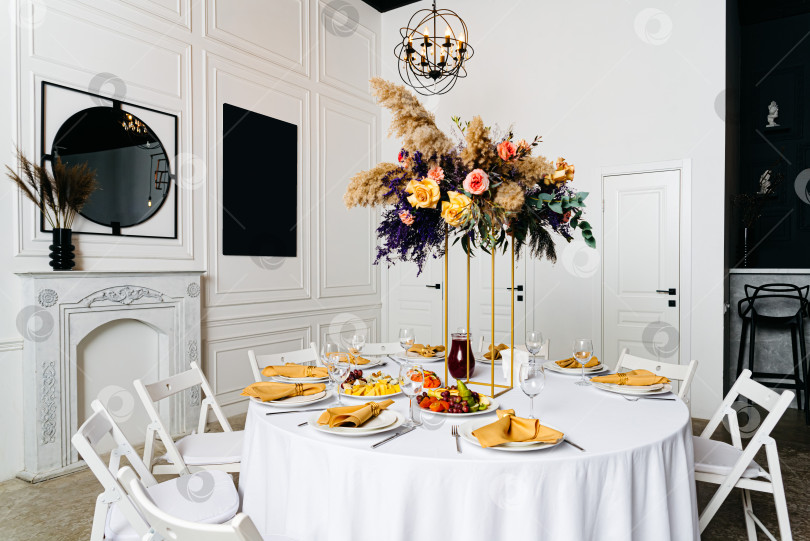 Скачать Элегантный обеденный стол с цветочным декором в центре фотосток Ozero