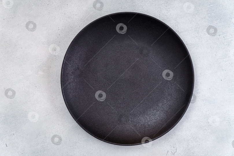 Скачать Пустая черная тарелка на светло-сером фоне фотосток Ozero